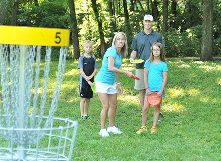 Family playing disc golf